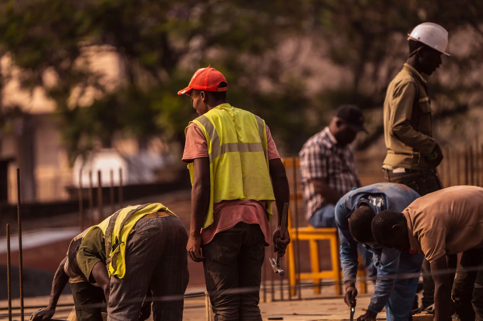 Construction workers in hard hats and hi-vis vests on a building site