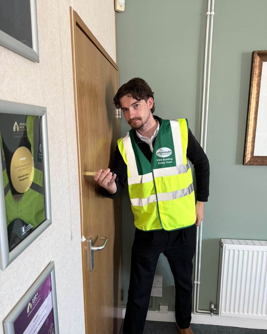 Jacob inspecting a flat entrance fire door